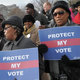 Activists hold pro-voting-rights placards outside the Supreme Court in Washington, D.C., on Feb. 27, 2013, as the court prepares to hear Shelby County v. Holder. The case centered on a key section of the 1965 Voting Rights Act mandating federal approval for any proposed voting changes in nine states.
MANDEL NGAN/AFP/Getty Images